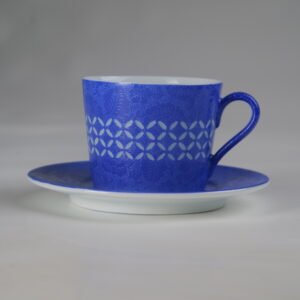 Side view of ultramarine porcelain coffee cup with saucer