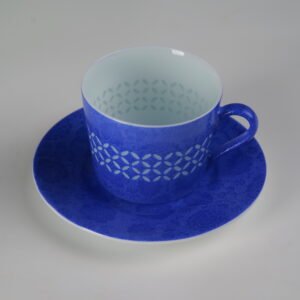High angle view of ultramarine porcelain cup on saucer