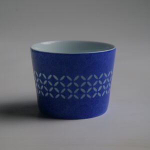 Back view of ultramarine porcelain cup showing coin pattern