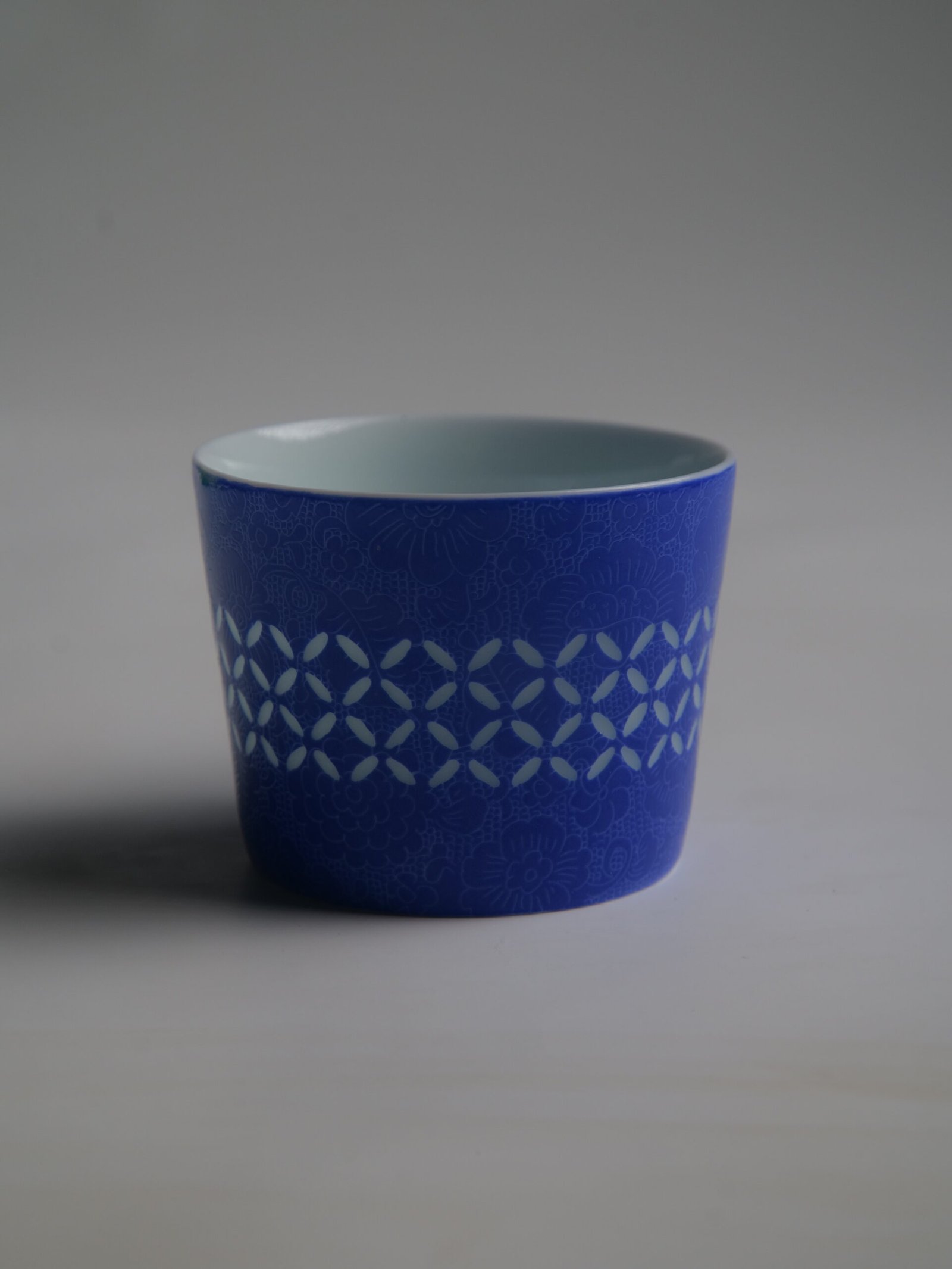 Ultramarine Coffee Cup – Pattern View Back view of ultramarine porcelain cup showing coin pattern