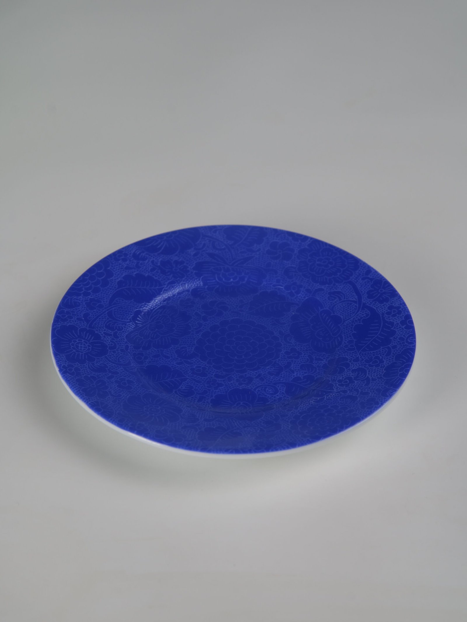 Ultramarine Coffee Cup – Saucer View Top view of ultramarine porcelain saucer with carved floral pattern