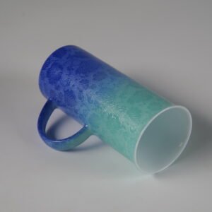 Tilted view of verdant blue porcelain aroma cup showing wide rim and interior
