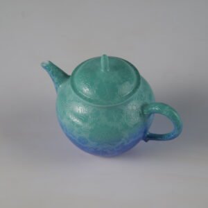 45-degree high angle view of verdant blue Pan's teapot showing intricate Pa Hua hundred flowers pattern