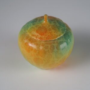 Top view of verdant clouds with orange hues porcelain melon-shaped jar with lid